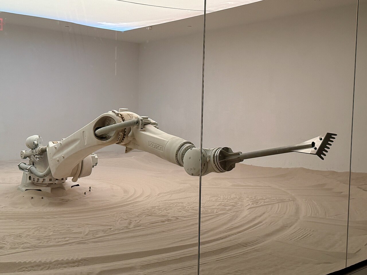 A six-axis articulated KUKA industrial robot arm extended in profile, its joints stacking from the base out to the end effector.