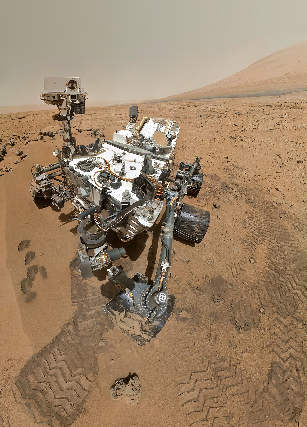 The Curiosity rover's high-resolution self-portrait on the surface of Mars, the unexplored landscape stretching out behind it.