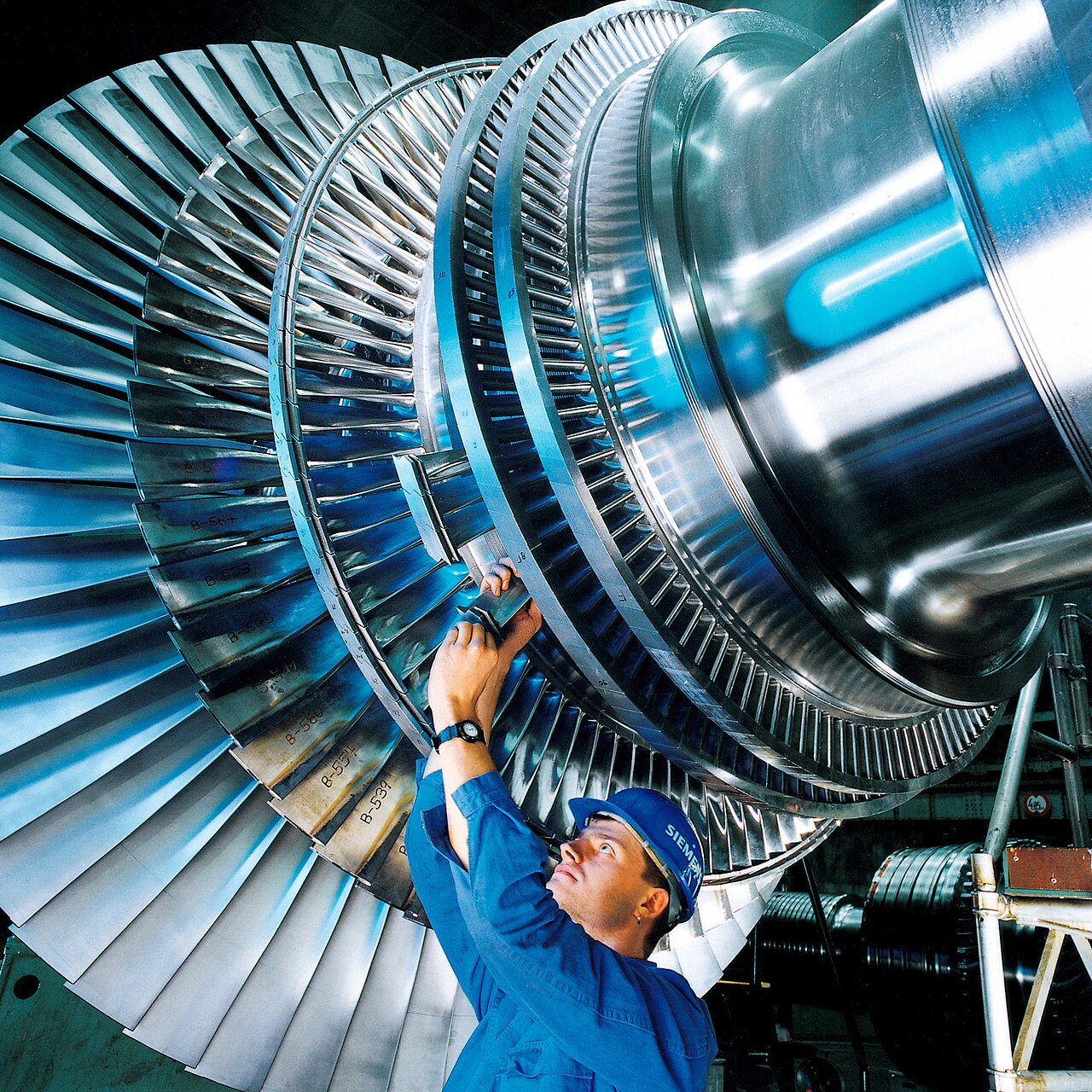 A steam-turbine rotor being assembled in a factory.